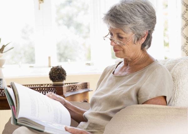 elderly woman reading in a chair